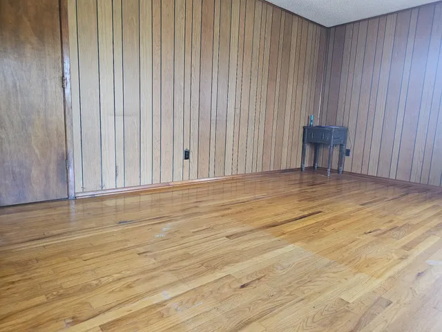 a view of a room with wooden floor and bench