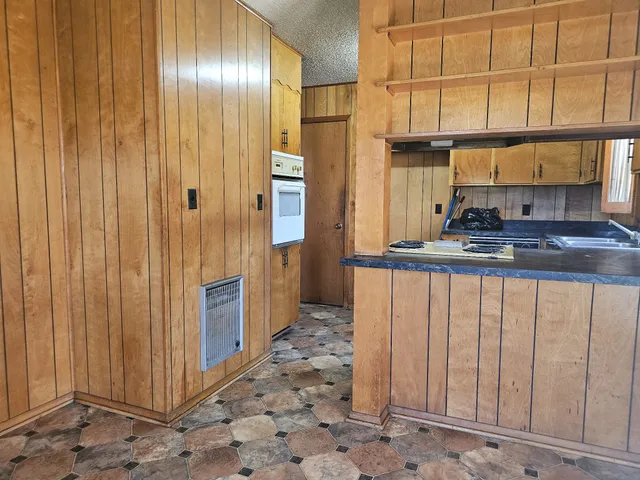 a kitchen with stainless steel appliances a refrigerator and cabinets