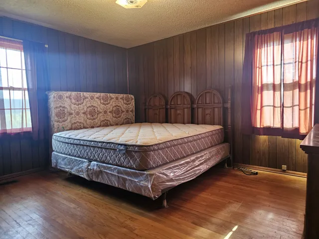 a bedroom with a bed and window