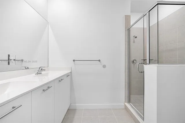 a bathroom with a double vanity sink and mirror