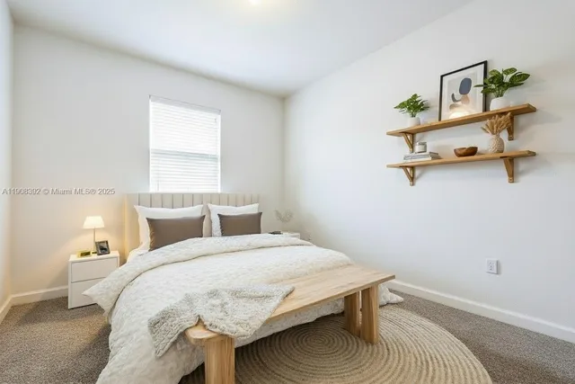 a bedroom with a bed and a table in it
