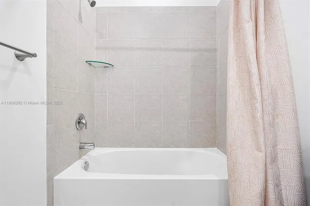 a white bath tub and shower