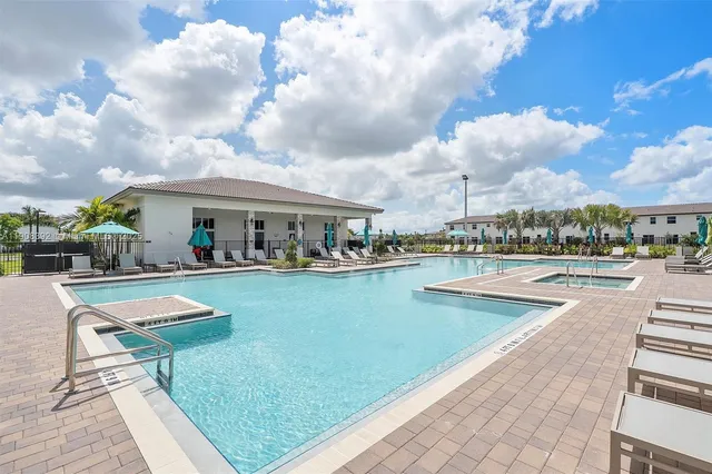 a view of swimming pool with outdoor seating and garden