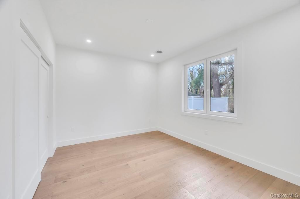 126 Rim Lane Hicksville, NY 11801 - Photo 17 of 28 Unfurnished bedroom featuring light wood-style floors, a closet, and recessed lighting