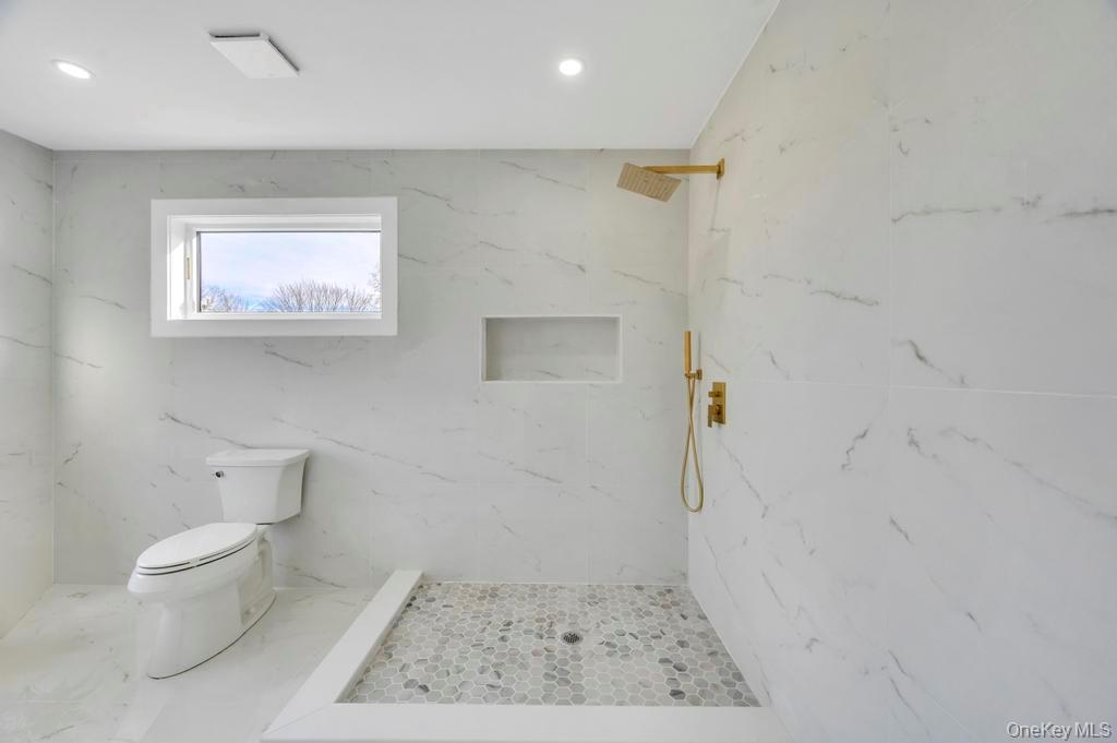 126 Rim Lane Hicksville, NY 11801 - Photo 20 of 28 Bathroom with a marble finish shower, stone wall, and recessed lighting
