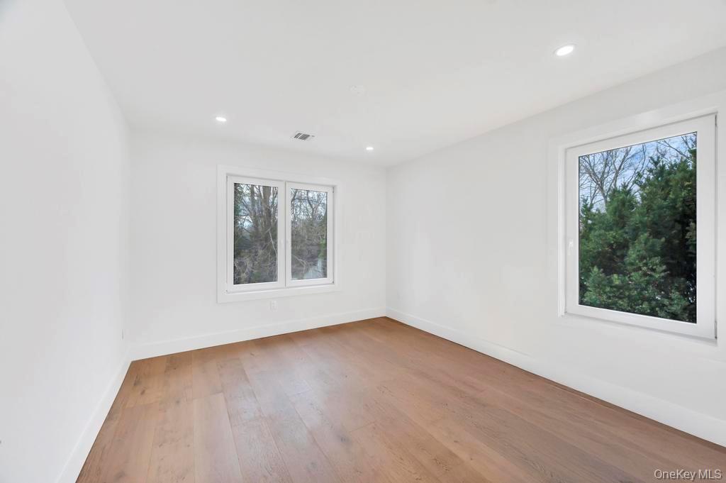 126 Rim Lane Hicksville, NY 11801 - Photo 21 of 28 Empty room with light wood-type flooring and recessed lighting