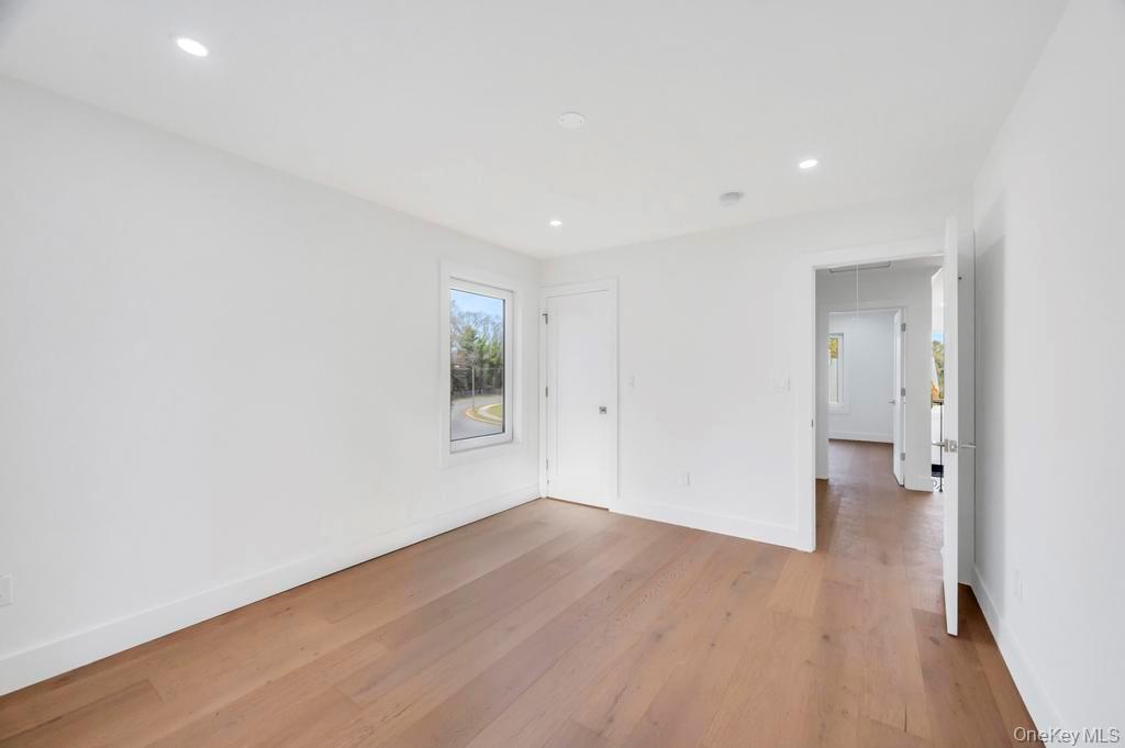 126 Rim Lane Hicksville, NY 11801 - Photo 23 of 28 Spare room with attic access, light wood-style floors, and recessed lighting