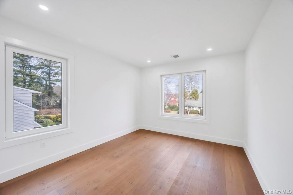 126 Rim Lane Hicksville, NY 11801 - Photo 24 of 28 Empty room with hardwood / wood-style floors and recessed lighting