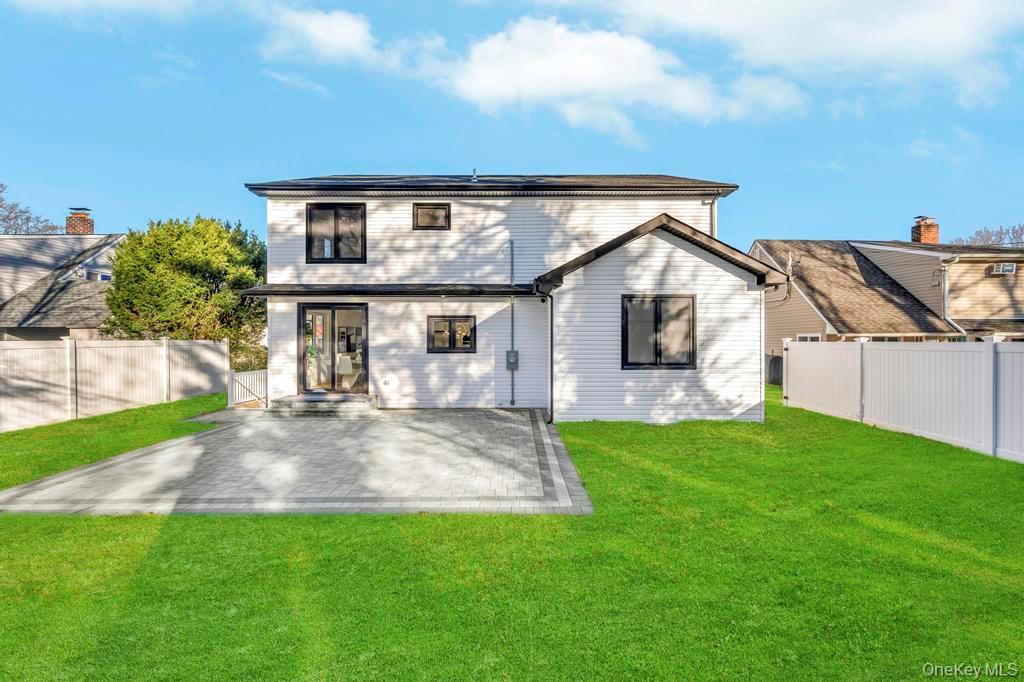 126 Rim Lane Hicksville, NY 11801 - Photo 3 of 28 Rear view of house with a patio area and a fenced backyard