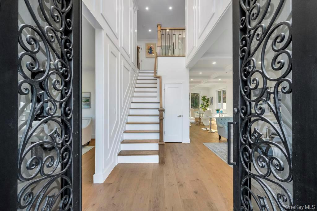 126 Rim Lane Hicksville, NY 11801 - Photo 4 of 28 Foyer entrance featuring stairway, light wood-style flooring, recessed lighting, and a towering ceiling