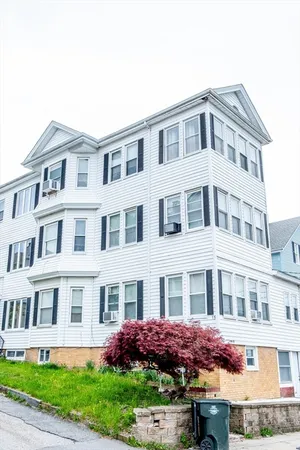 a front view of a residential apartment building with a yard