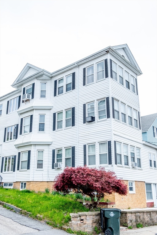 15 Oliver Street Fall River, MA 02724 - Photo 1 of 18 a front view of a residential apartment building with a yard
