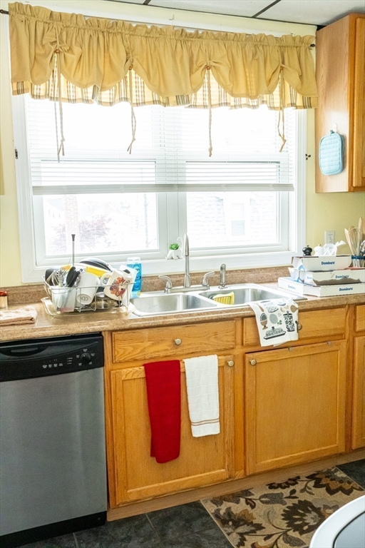 15 Oliver Street Fall River, MA 02724 - Photo 13 of 18 a kitchen with stainless steel appliances granite countertop a sink and a stove
