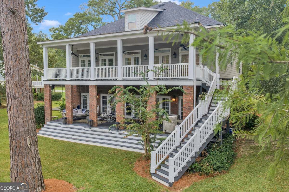 696 Cork Ferry Road Cordele, GA 31015 - Photo 52 of 79 a front view of a house with a yard table and chairs