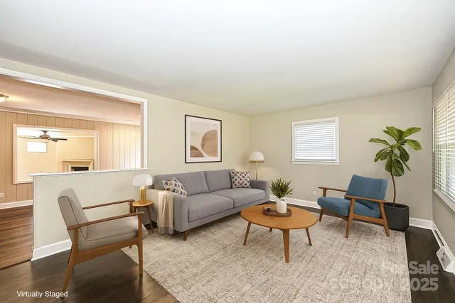 a living room with furniture a rug a lamp and a window