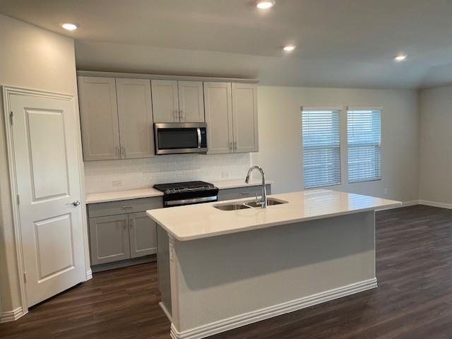 3116 Kingsgarden Road Denton, TX 76207 - Photo 4 of 20 a kitchen with granite countertop a sink and a stove top oven