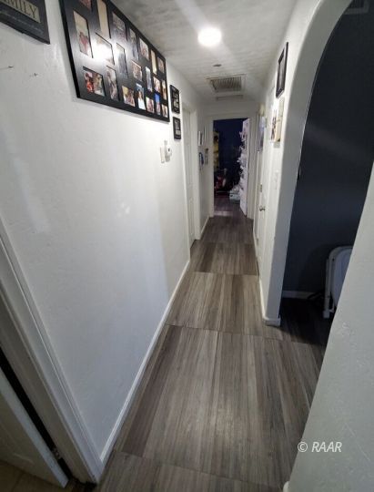 425 North Norma Street Ridgecrest, CA 93555 - Photo 10 of 33 a view of a hallway with wooden floor and staircase