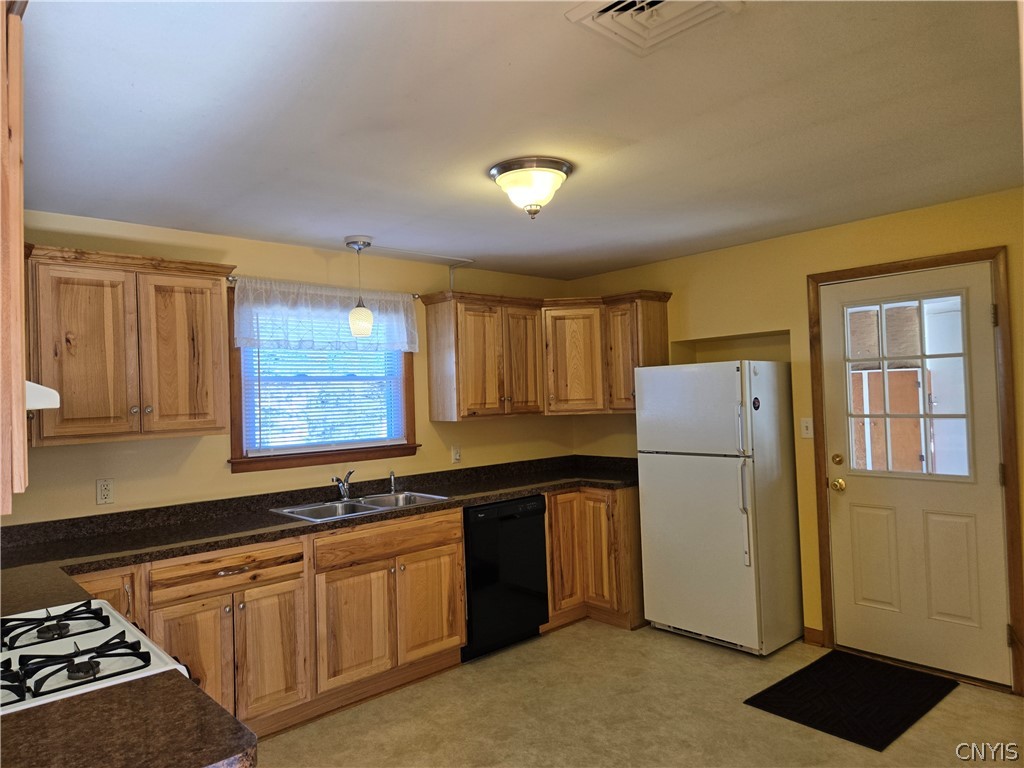 417 Locust Drive Utica, NY 13502 - Photo 5 of 25 Gas stove, dishwasher, and refrigerator are in pla