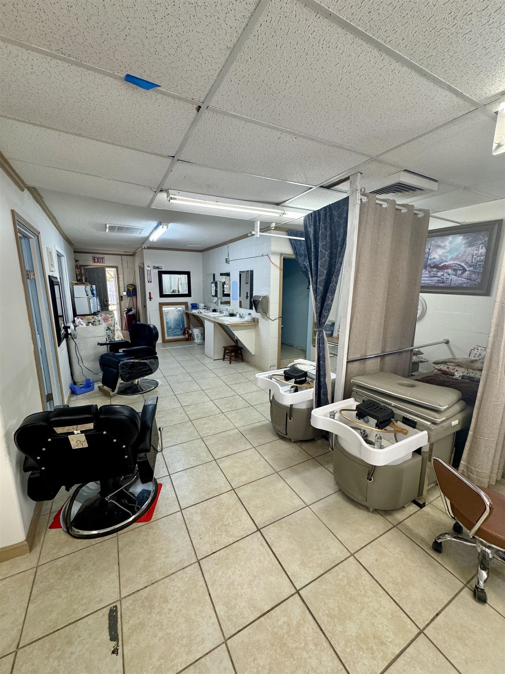 289 Washington Street Ripley, TN 38063 - Photo 7 of 10 a living room with furniture a flat screen tv and gym equipment
