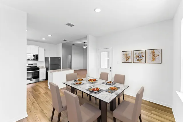 a view of a dining room with furniture and wooden floor