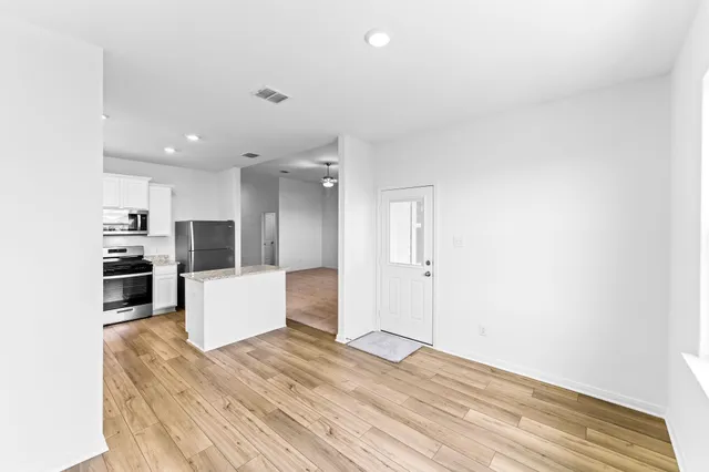 a kitchen with stainless steel appliances a refrigerator and a stove top oven