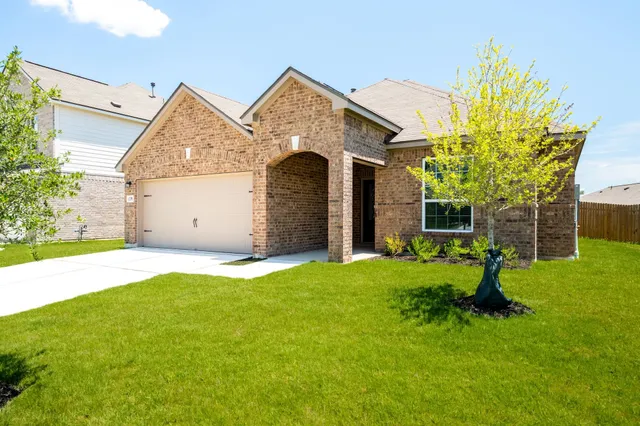 a front view of a house with a yard garage and outdoor seating