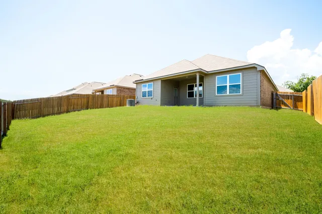 a front view of house with yard and trees