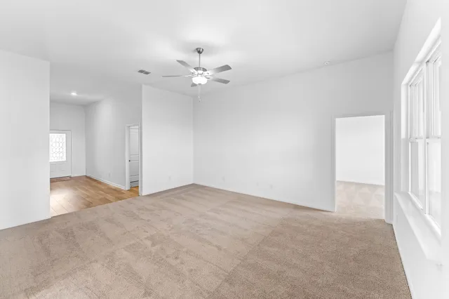 an empty room with fan and a ceiling fan