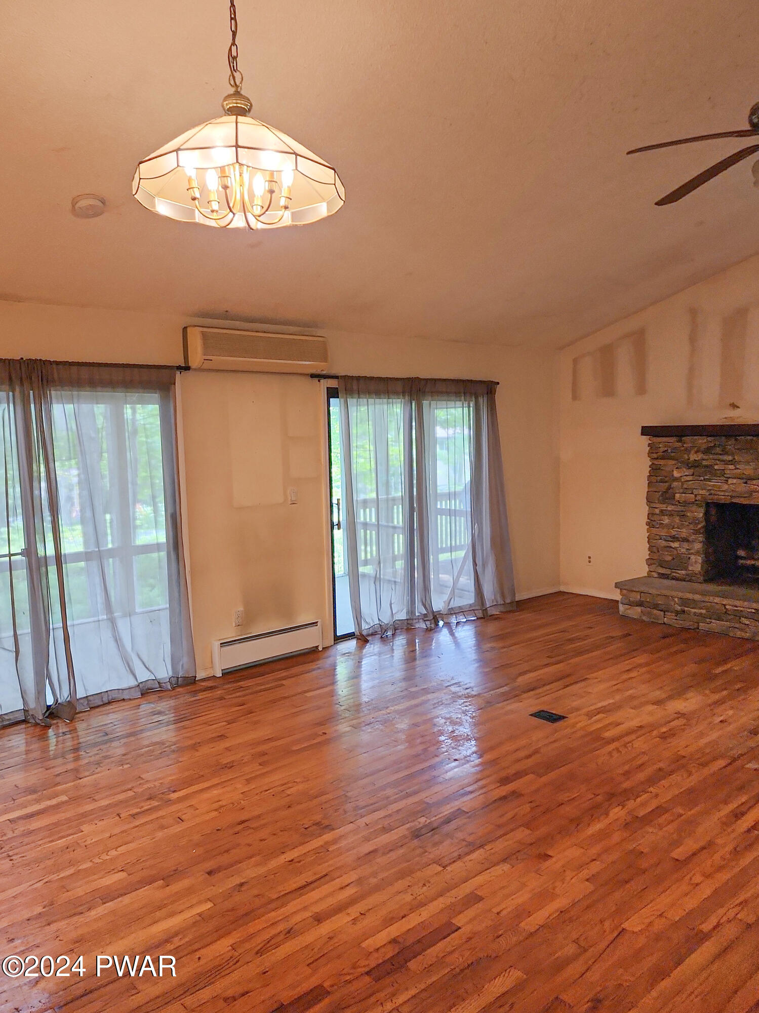 107 Rodeo Lane Hawley, PA 18428 - Photo 5 of 29 a view of an empty room with wooden floor and a window