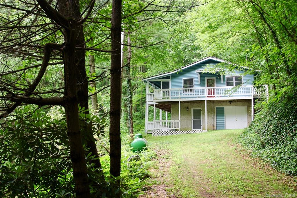 149 Irwin Way Clyde, NC 28721 - Photo 2 of 29 a front view of a house with a garden