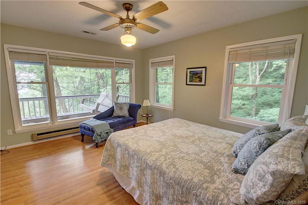 149 Irwin Way Clyde, NC 28721 - Photo 11 of 29 a spacious bedroom with a bed and a large window