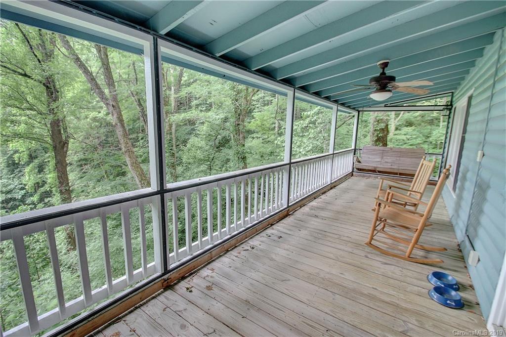 149 Irwin Way Clyde, NC 28721 - Photo 14 of 29 a view of a porch with wooden floor and outdoor space