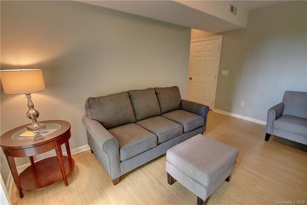 149 Irwin Way Clyde, NC 28721 - Photo 18 of 29 a living room with furniture a lamp and a couch