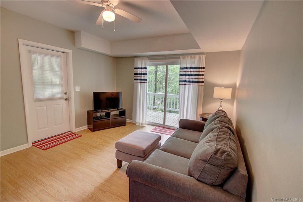 149 Irwin Way Clyde, NC 28721 - Photo 19 of 29 a living room with furniture and a flat screen tv