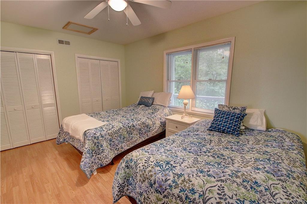 149 Irwin Way Clyde, NC 28721 - Photo 20 of 29 a bedroom with two beds and a chandelier