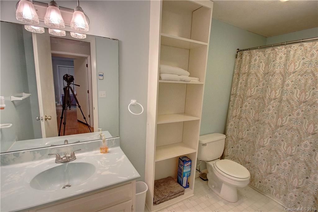 149 Irwin Way Clyde, NC 28721 - Photo 21 of 29 a bathroom with a sink a toilet and shower