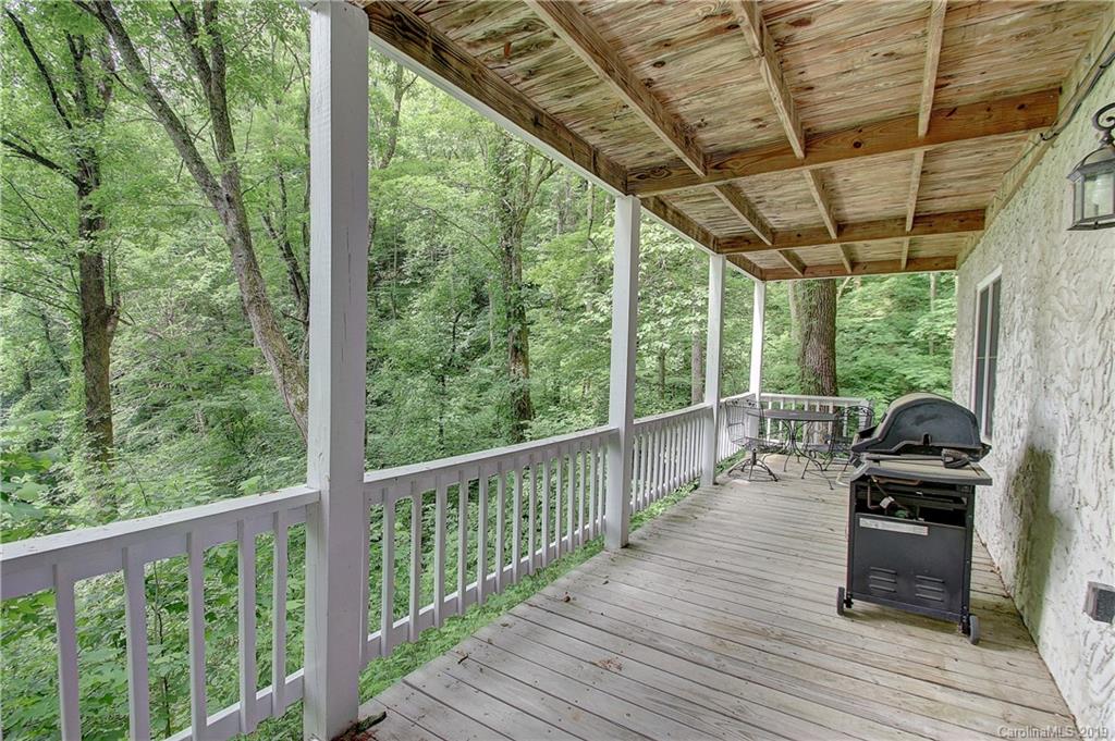 149 Irwin Way Clyde, NC 28721 - Photo 22 of 29 a view of balcony with couch and wooden floor