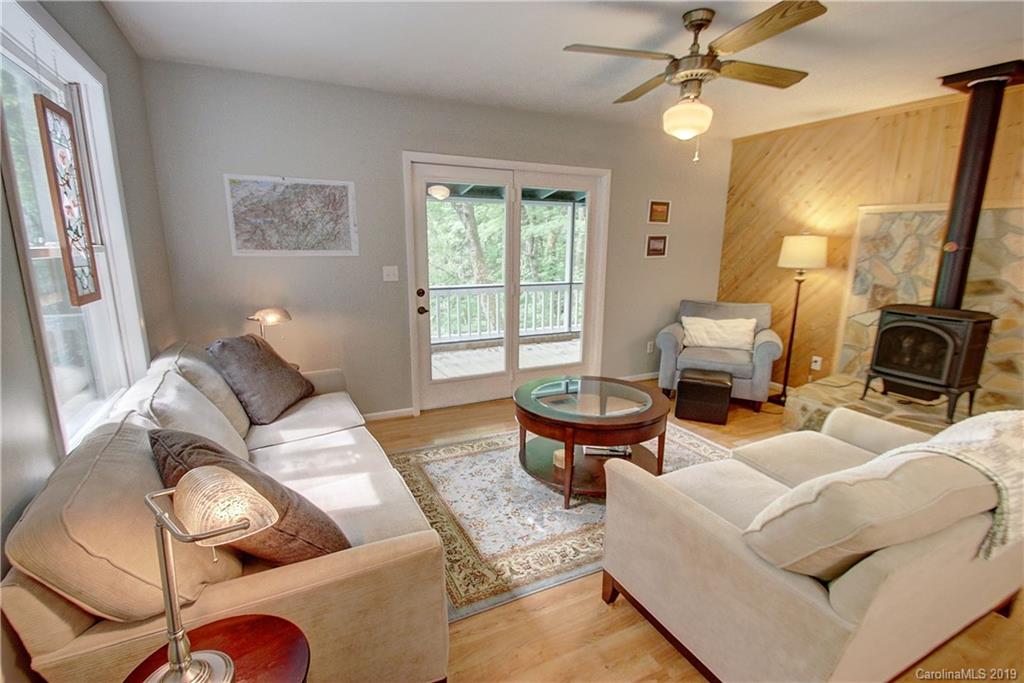 149 Irwin Way Clyde, NC 28721 - Photo 6 of 29 a living room with furniture a fireplace and a window