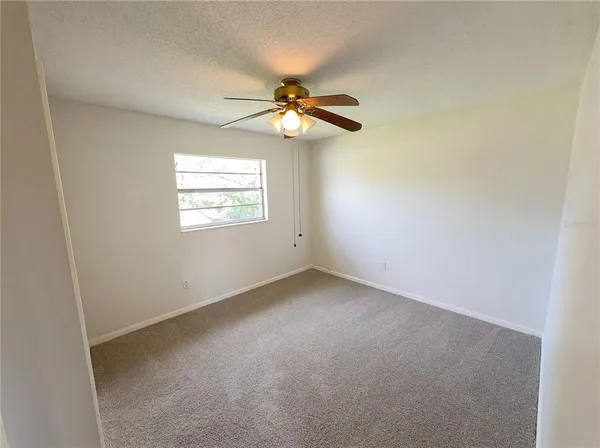 a view of a chandelier and window in an empty room