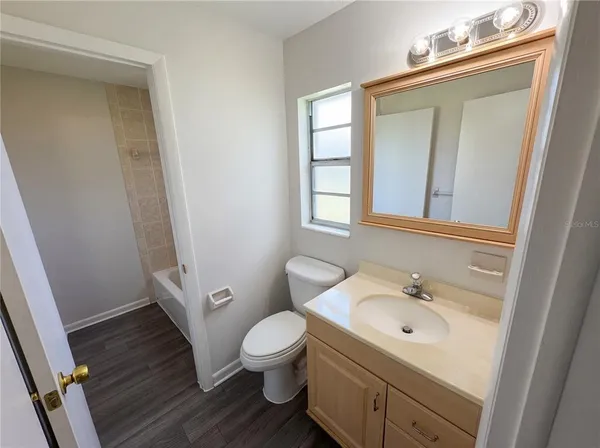 a bathroom with a sink a mirror and a toilet
