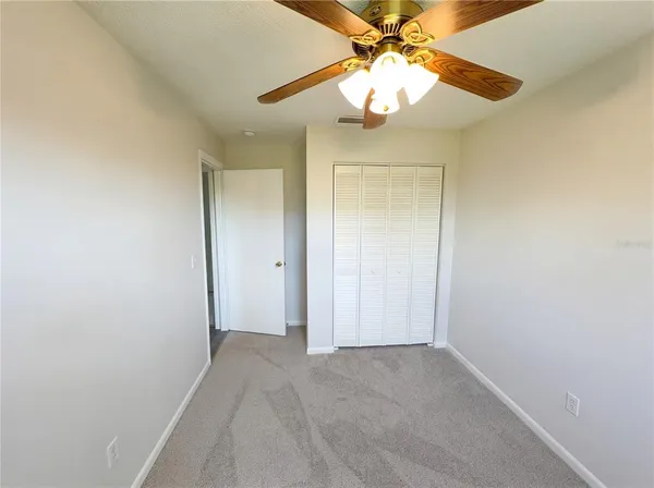 wooden floor in an empty room with a bathroom