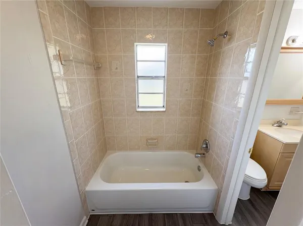 a bath tub sitting next to a white toilet