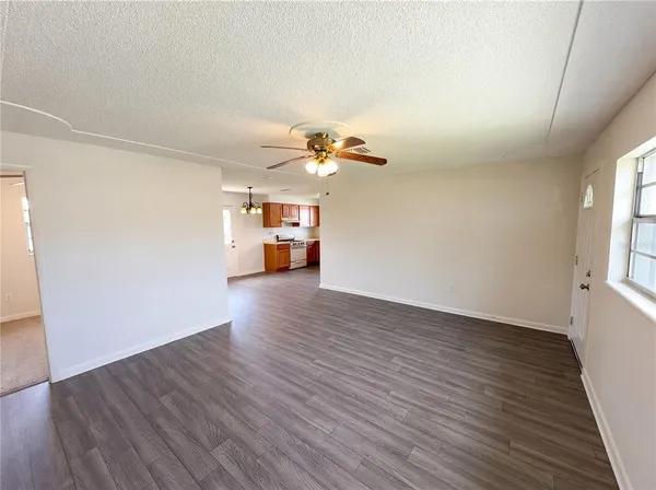 a view of kitchen with sink and wooden floor