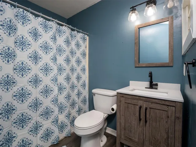 a bathroom with a sink toilet and mirror