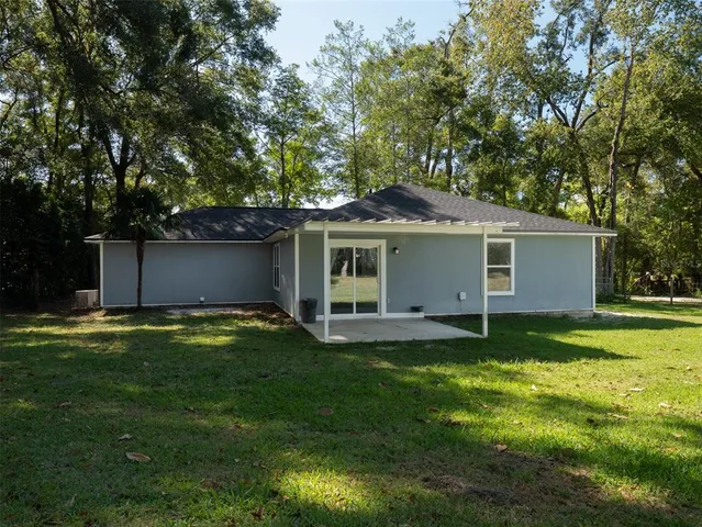 a view of a house with a yard and a garden