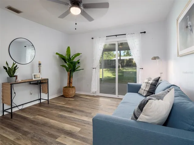 a living room with furniture a window and a potted plant