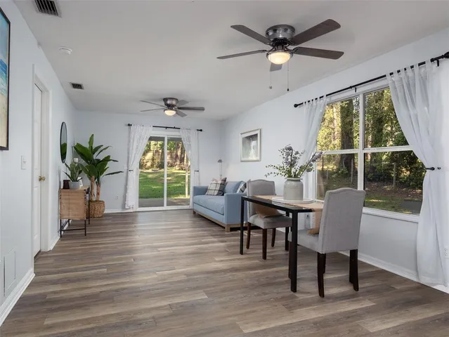 a view of a livingroom with furniture window and wooden floor