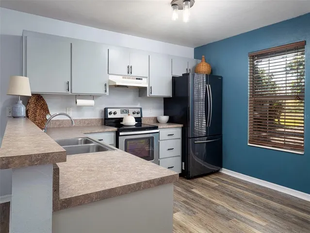 a kitchen with granite countertop stainless steel appliances and wooden cabinets