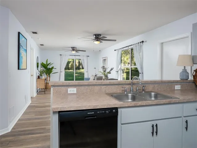 a kitchen with granite countertop a sink and a window