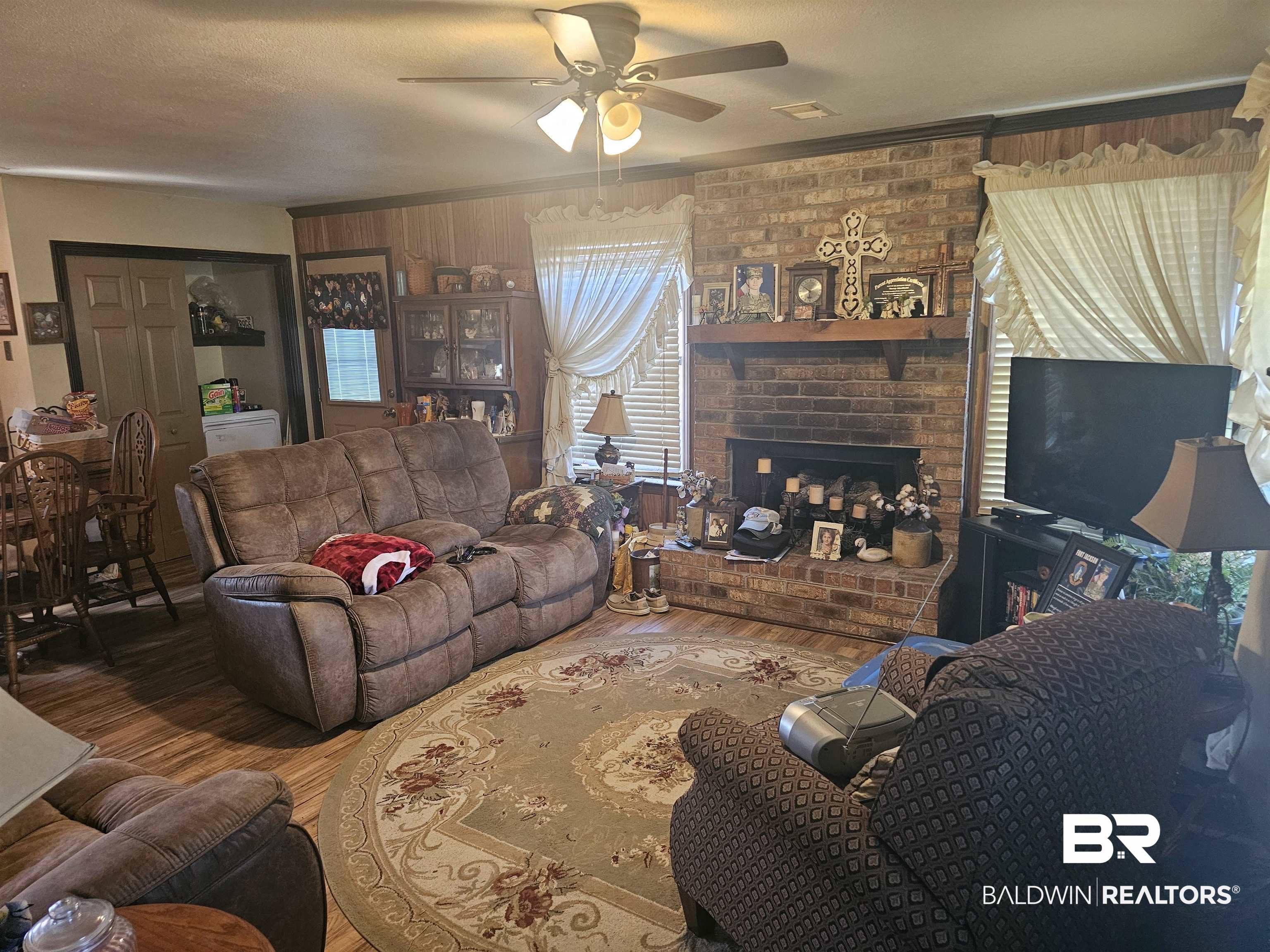 1818 Old Fannie Road Flomaton, AL 36441 - Photo 9 of 20 Living room featuring wood finished floors, ceiling fan, and a fireplace